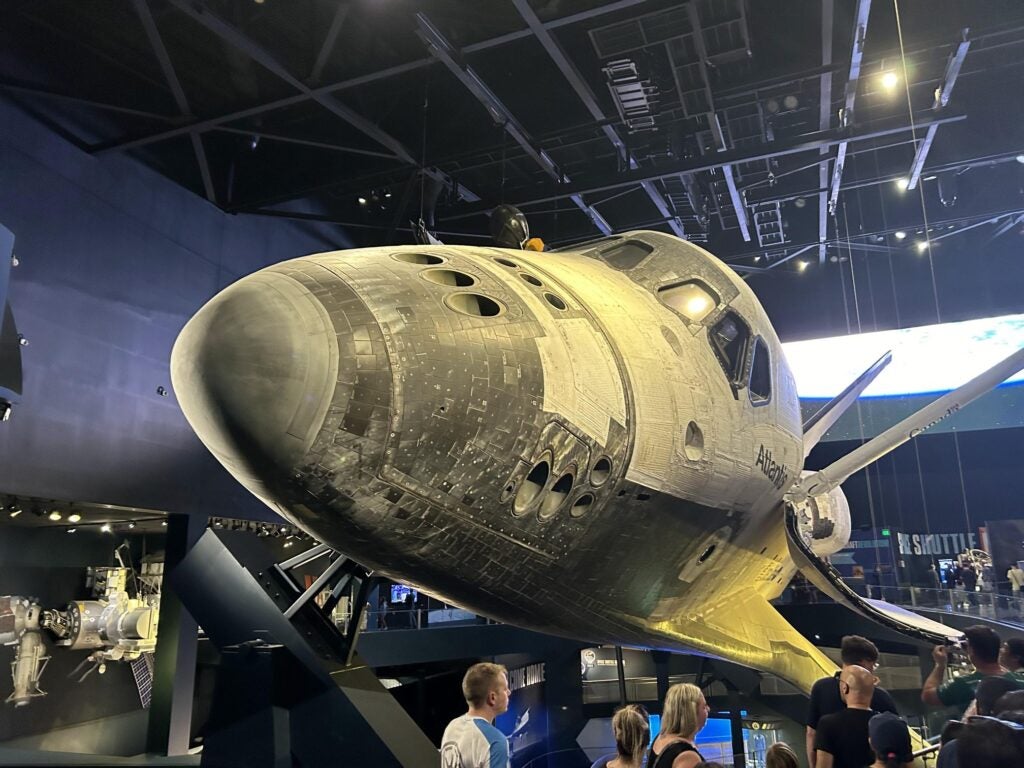 astronaut chatting and Space Shuttle Atlantis